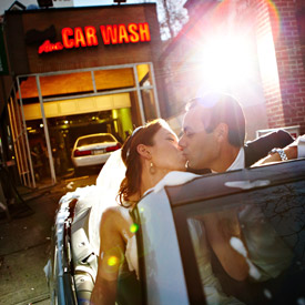 bride and groom in a convertible at the carwash